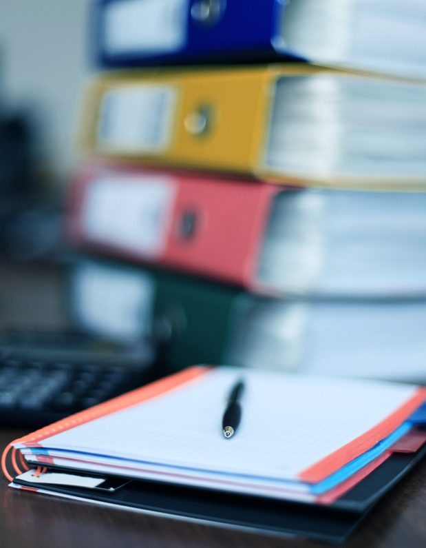 Office supplies and coffee cup on table